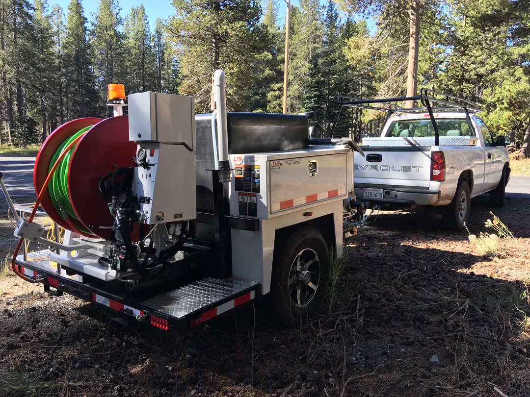 District crew cleaning a gravity sewer line in the field.