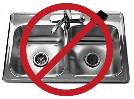 Fats, oils and grease being poured into a kitchen sink — the practice the FOG program discourages.